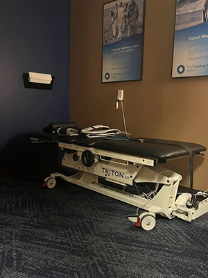Chiropractic Oakdale MN Decompression Table A decompression table in a room with yellow walls.