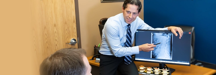Chiropractor Oakdale MN Benjamin Smetana Pointing To A Patients XRay